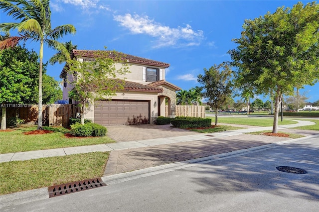 mediterranean / spanish house featuring a front lawn and a garage