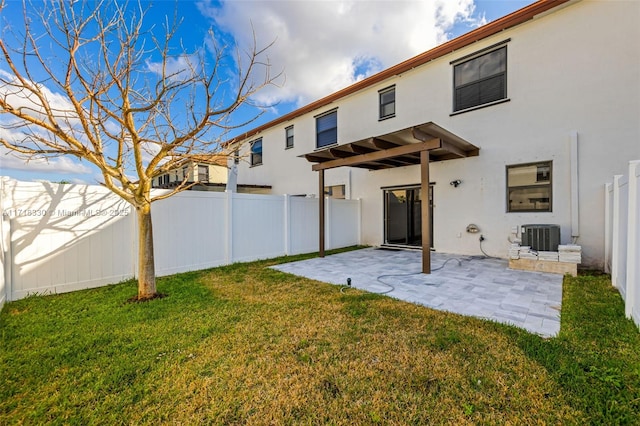 rear view of house featuring a yard, cooling unit, and a patio