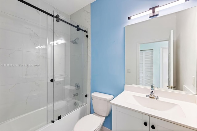 full bathroom featuring vanity, toilet, and bath / shower combo with glass door