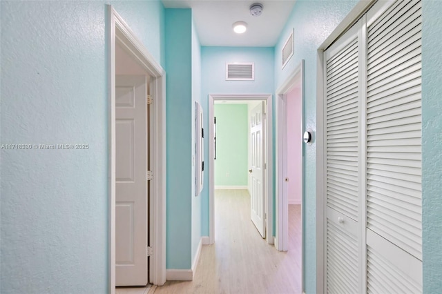 hallway with light wood-type flooring