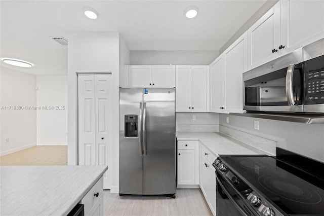 kitchen with white cabinetry and appliances with stainless steel finishes