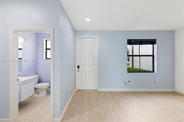 interior space featuring vanity, hardwood / wood-style flooring, and toilet