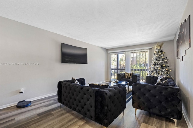 living room with a textured ceiling and hardwood / wood-style flooring