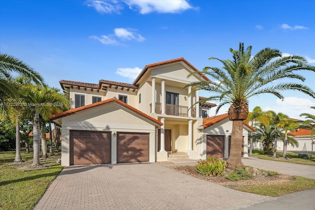 mediterranean / spanish-style house with a balcony and a garage