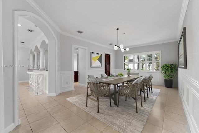 dining room featuring ornamental molding, a chandelier, and light tile patterned floors