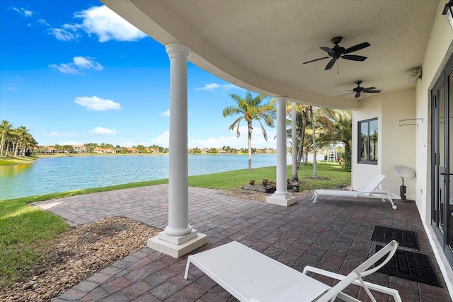 view of patio / terrace featuring ceiling fan and a water view