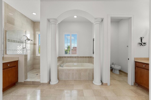 bathroom featuring vanity, ornate columns, shower with separate bathtub, and a bidet