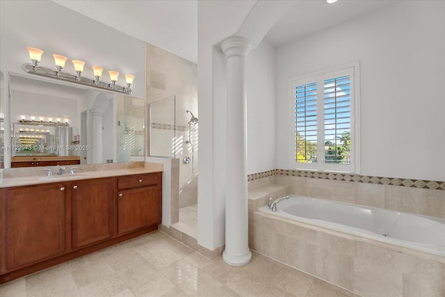 bathroom with vanity, decorative columns, and separate shower and tub