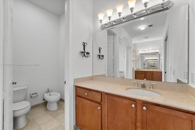 bathroom featuring decorative columns, vanity, a bidet, and toilet