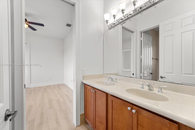 bathroom with vanity, hardwood / wood-style floors, and ceiling fan