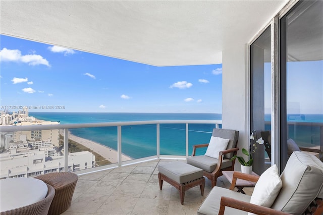 balcony with a water view and a beach view