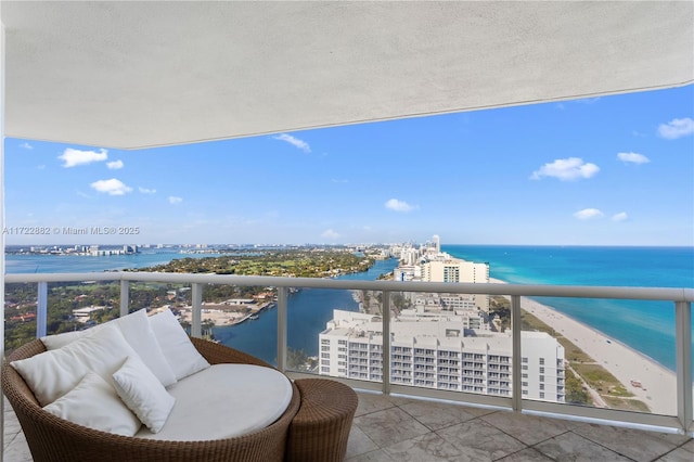 balcony featuring a water view and a view of the beach