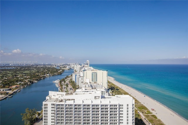 bird's eye view with a water view and a beach view