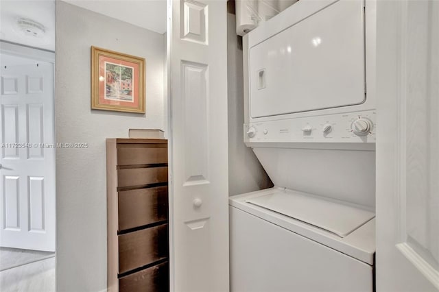 washroom with stacked washer and dryer