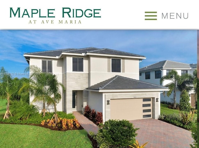 view of front of house featuring a front yard and a garage