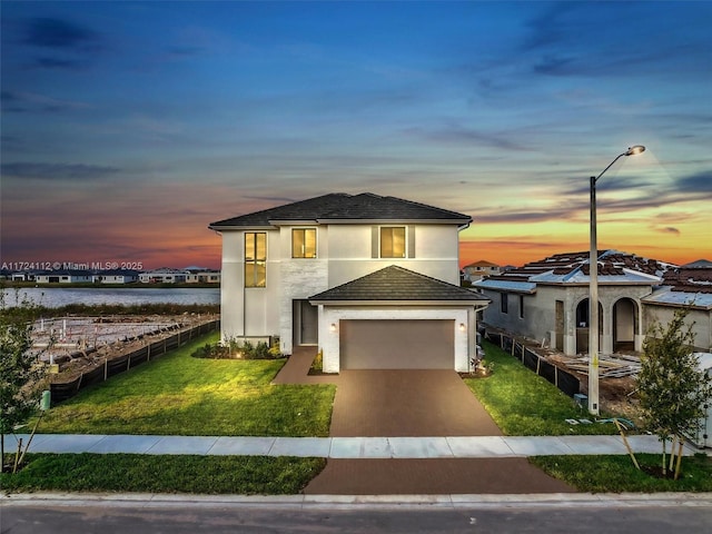 view of front of house with a water view and a yard