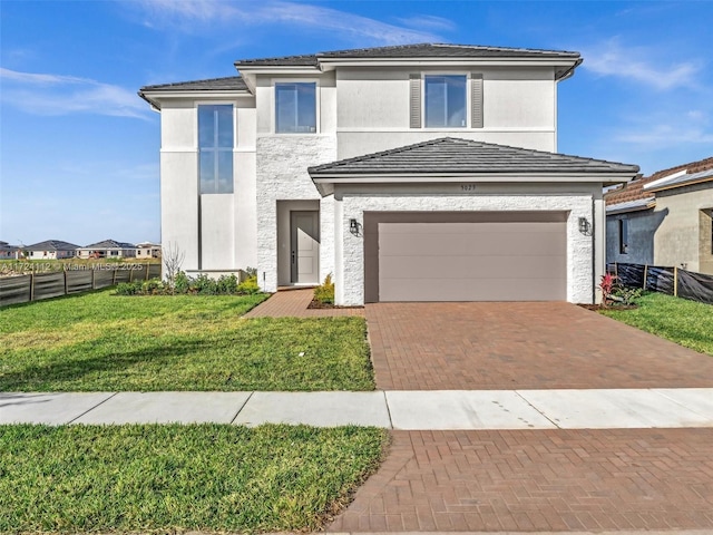 view of front facade with a garage and a front lawn