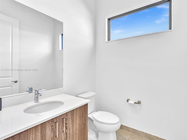 bathroom featuring toilet, vanity, and tile patterned flooring