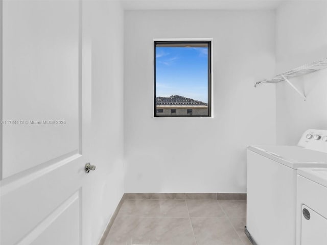 laundry area featuring light tile patterned floors and separate washer and dryer