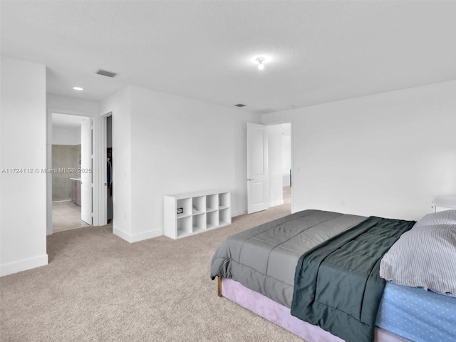 carpeted bedroom featuring ensuite bathroom