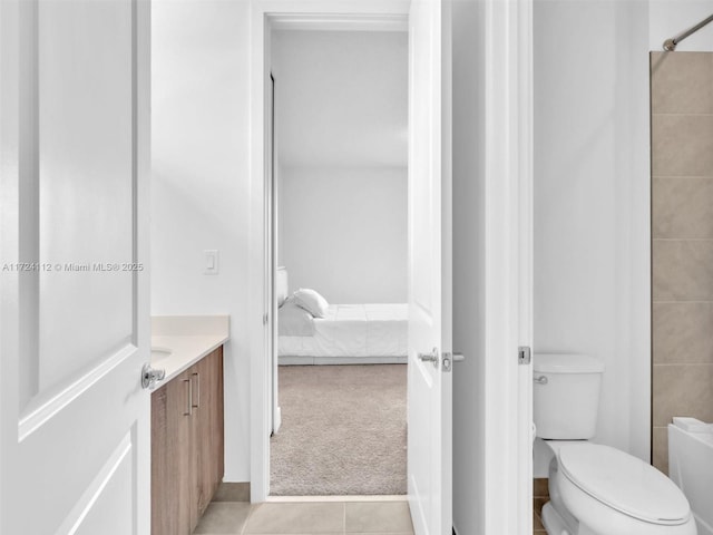 bathroom with toilet, tile patterned floors, and vanity