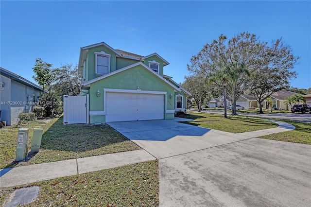 view of property with a front lawn and a garage