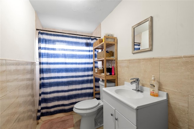 bathroom featuring walk in shower, tile patterned flooring, toilet, vanity, and tile walls