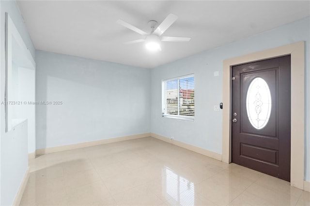 tiled entrance foyer featuring ceiling fan