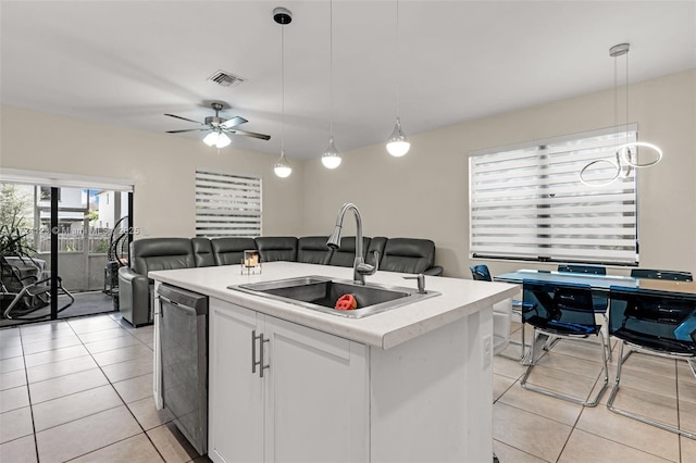 kitchen featuring dishwasher, an island with sink, white cabinets, decorative light fixtures, and sink