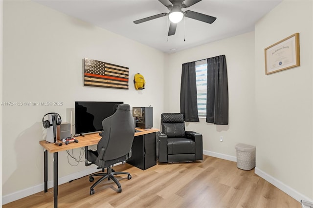 home office featuring ceiling fan and light hardwood / wood-style flooring