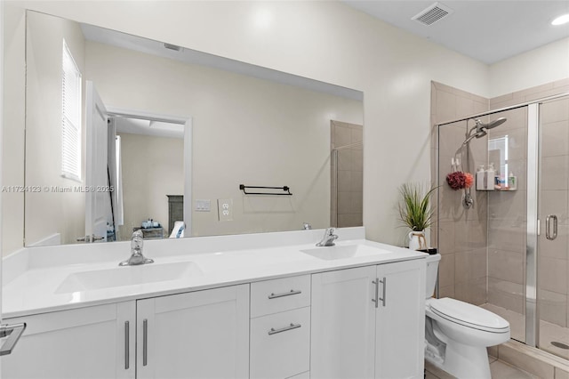 bathroom with toilet, tile patterned flooring, walk in shower, and vanity