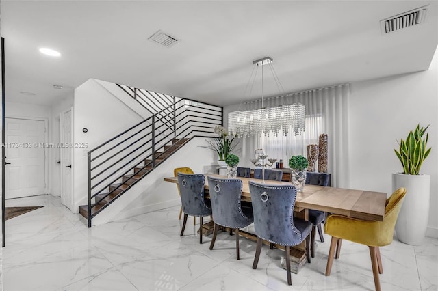 dining space featuring an inviting chandelier