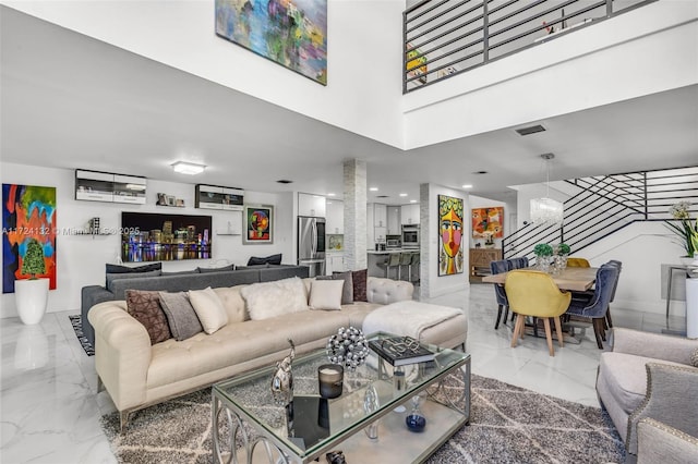 living room featuring a towering ceiling