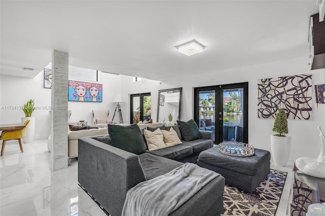 living room featuring french doors and decorative columns