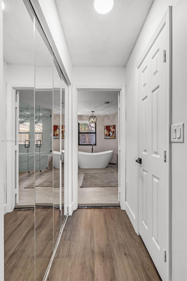 corridor featuring hardwood / wood-style flooring