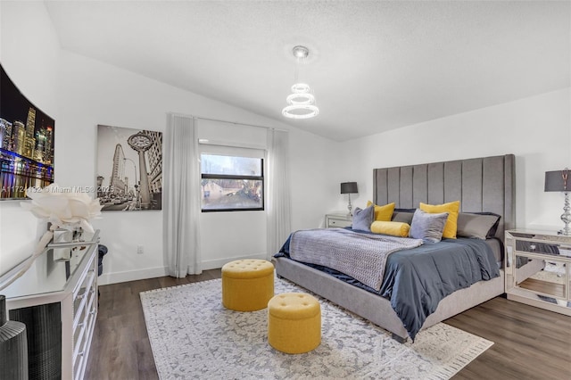 bedroom with dark wood-type flooring and vaulted ceiling