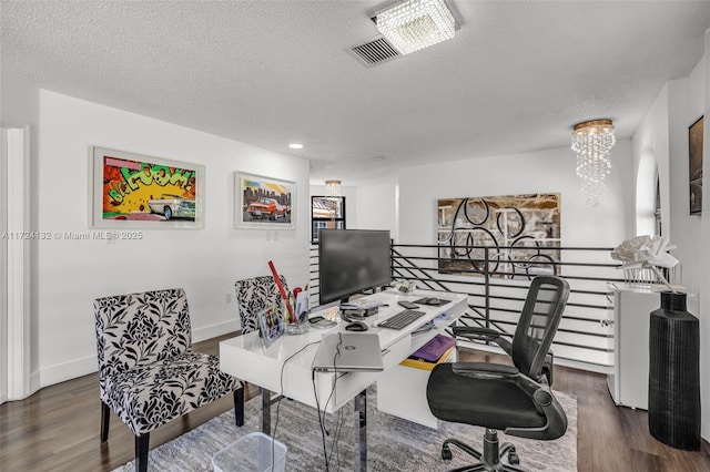 home office with dark wood-type flooring, a textured ceiling, and a chandelier