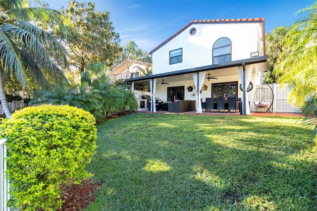 rear view of property with a yard, an outdoor hangout area, ceiling fan, and a patio area