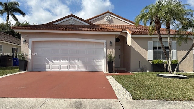 view of front of home with a garage and a front lawn