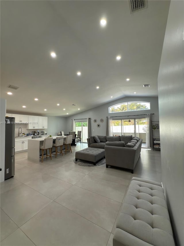 living room with vaulted ceiling and sink