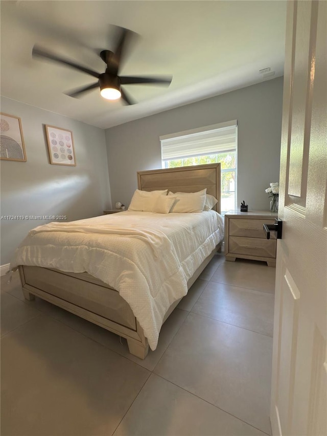 bedroom featuring tile patterned floors and ceiling fan