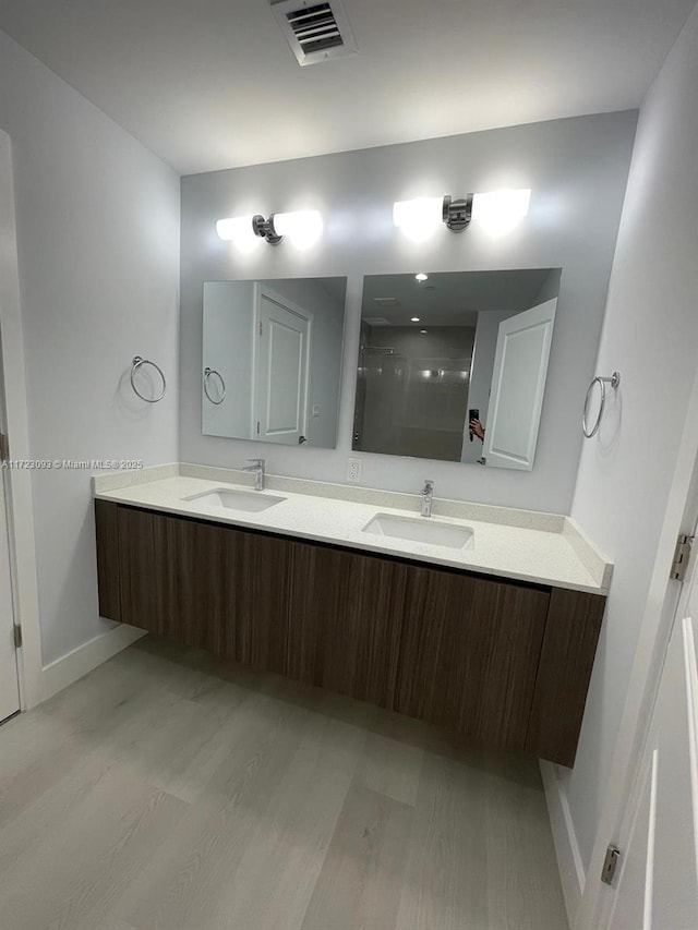 bathroom with vanity and wood-type flooring