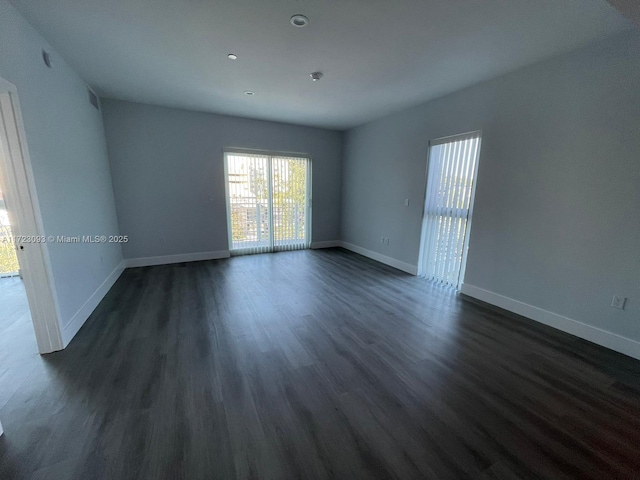 empty room with dark wood-type flooring