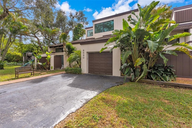 view of front facade with a front yard and a garage