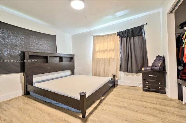 bedroom featuring a closet and light hardwood / wood-style flooring