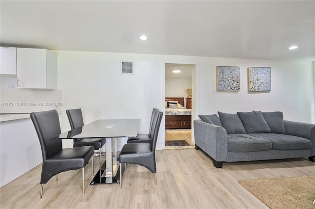 dining area with light wood-style floors, visible vents, and recessed lighting