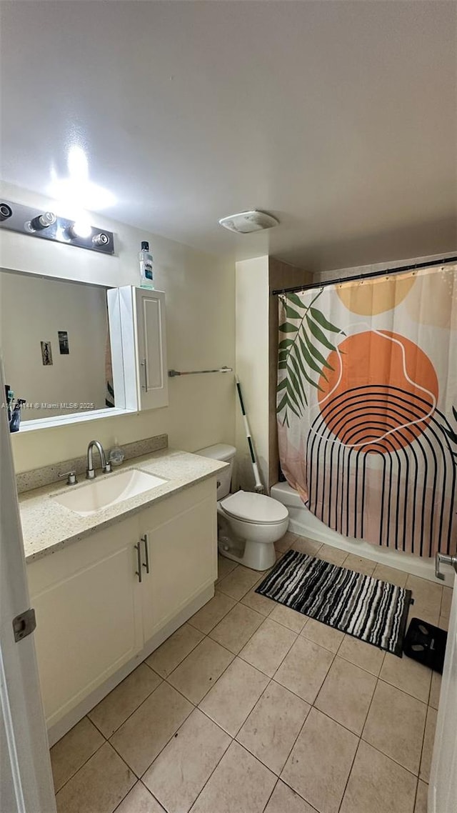 bathroom featuring toilet, tile patterned flooring, and vanity