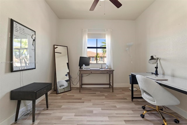 home office with light wood-type flooring and ceiling fan