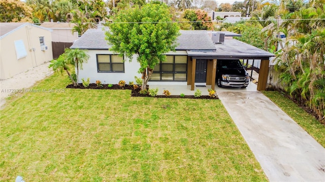 view of front facade with a front yard and a carport