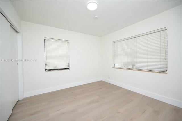 spare room with light hardwood / wood-style floors